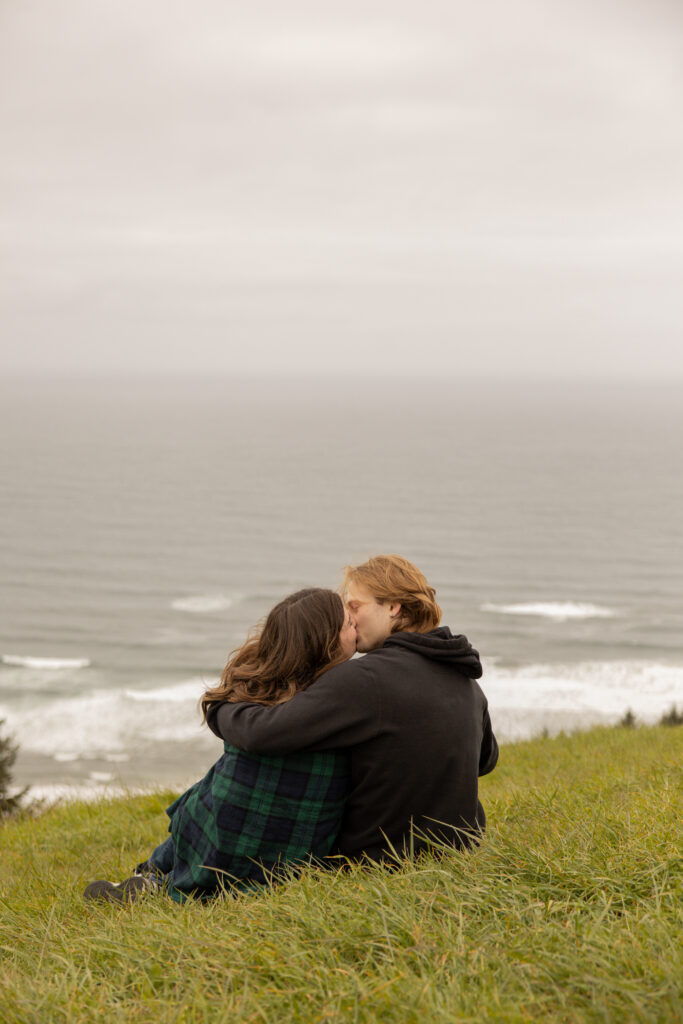 Engaged couple sitting taken by Oregon engagement photographer.