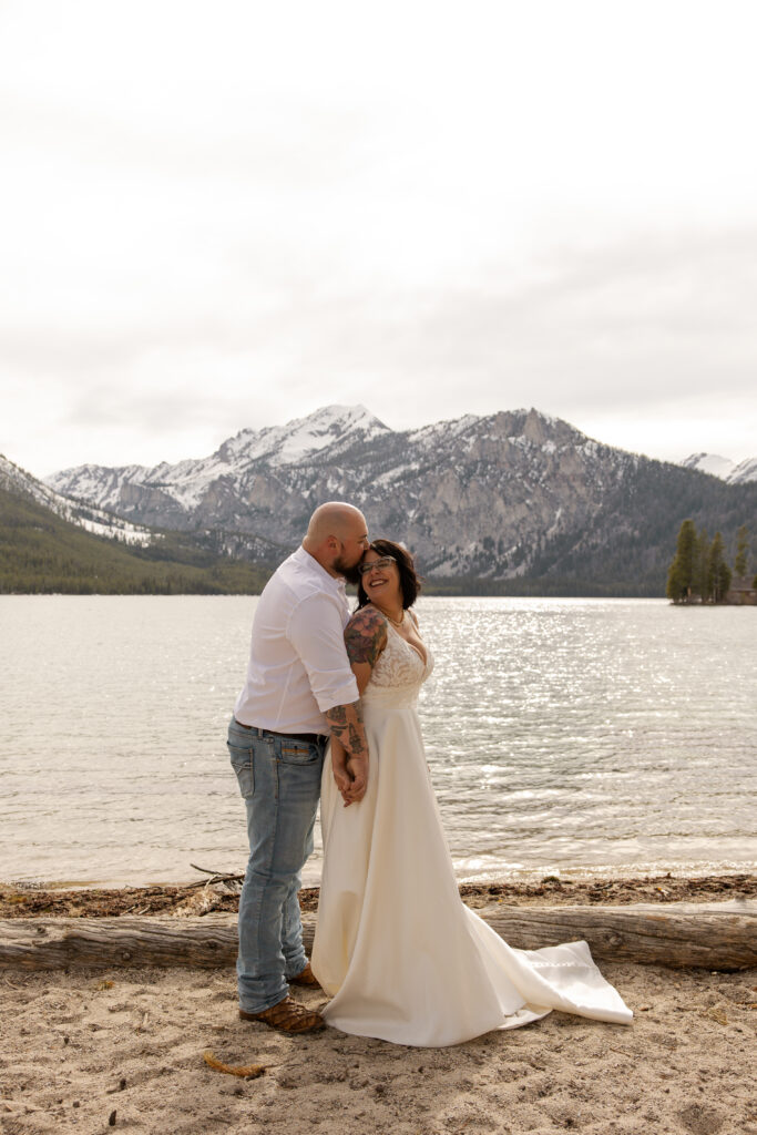 Husband and wife gaze at each other in the sawtooth range after eloping in Idaho