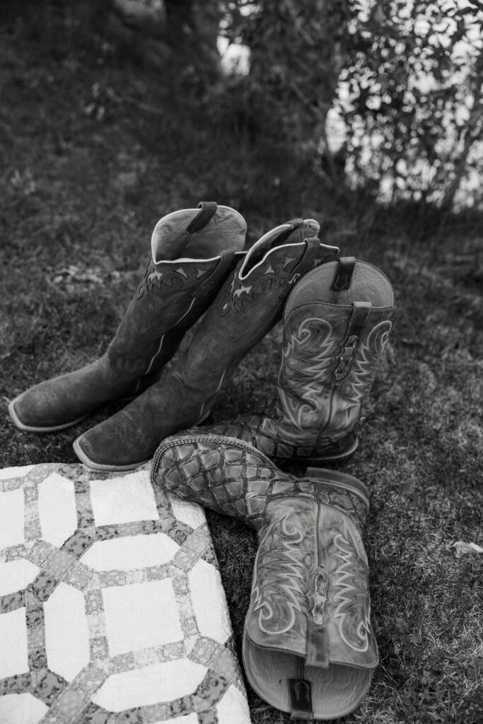 Cowboy boots for husband and wife laying on the ground for them to be worn while eloping in Idaho