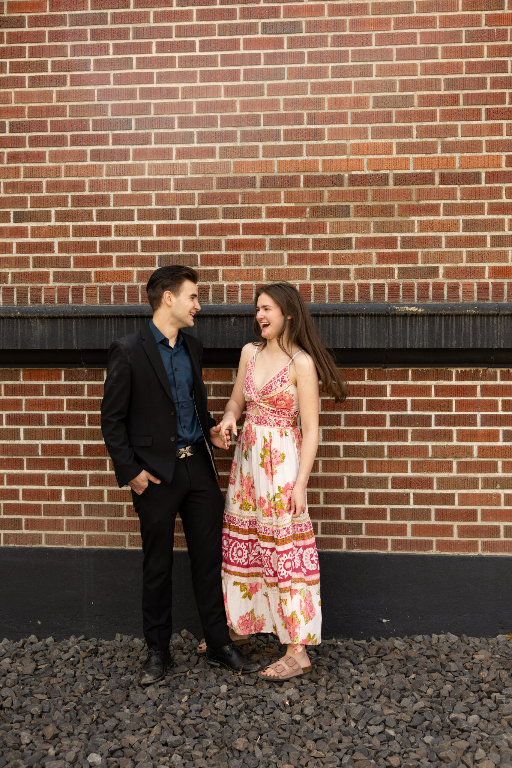 Engaged couple laughing taken by proposal photographer