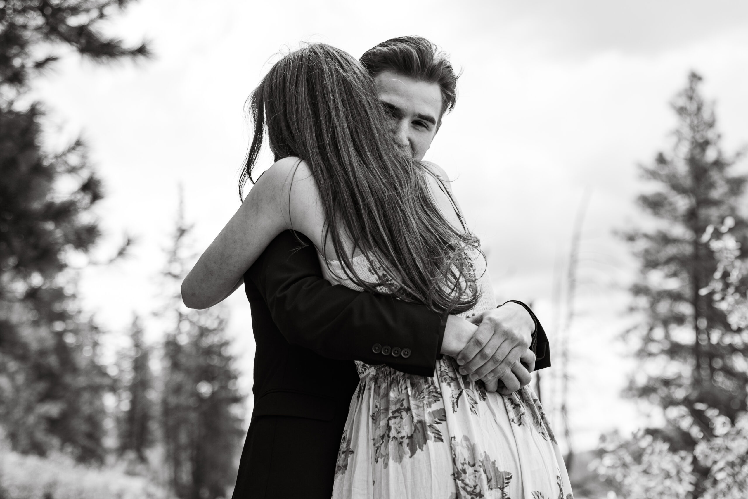 Engaged couple hugging taken by proposal photographer