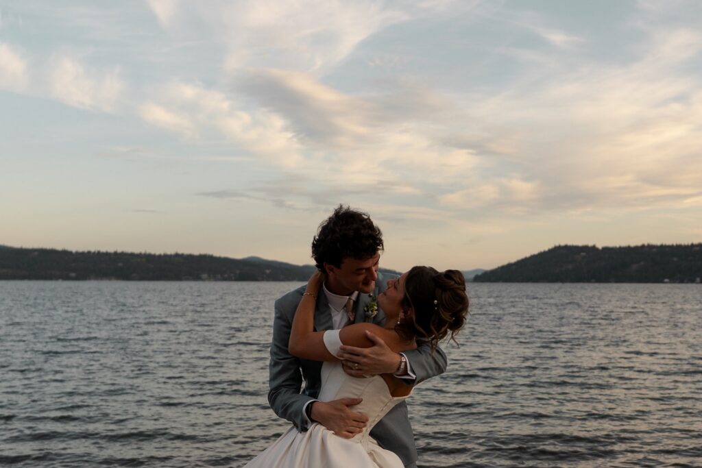 Bride and Groom look at each other at a lake while eloping in Idaho