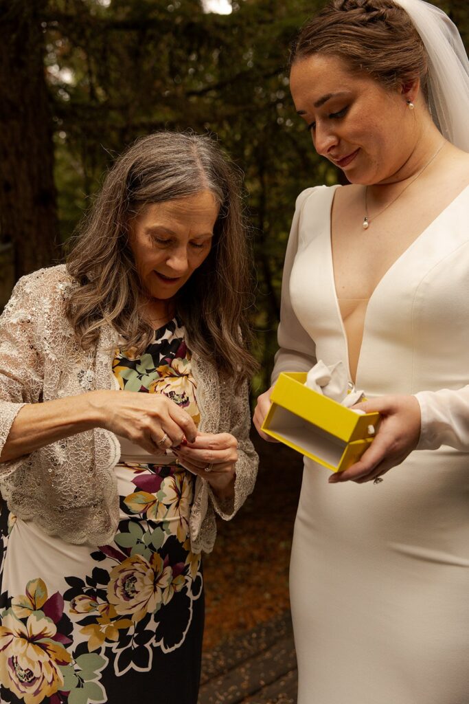 Mother of the Bride opens a gift with her daughter when she is eloping in Idaho