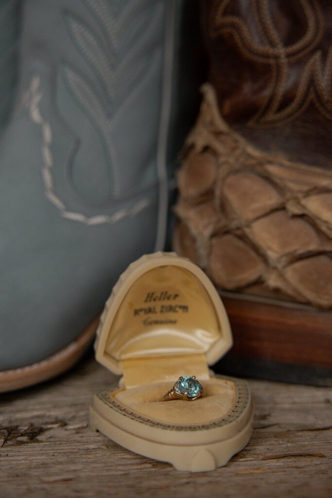 Blue wedding ring on display in case newt to matching blue boots made for eloping in Idaho