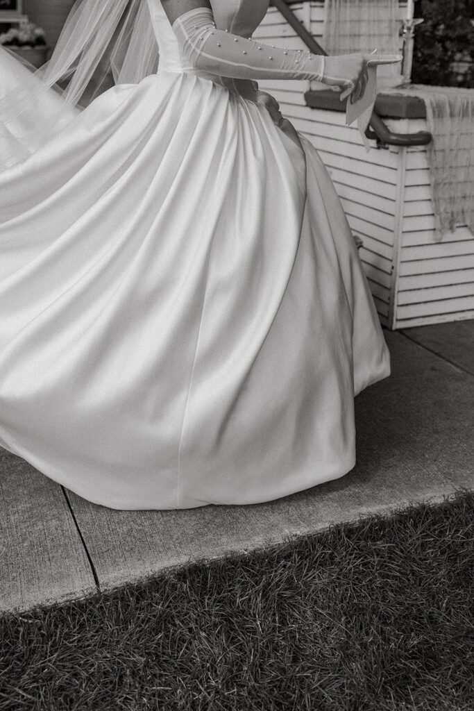 A bride in her white dress and gloves prepares to elope in Idaho