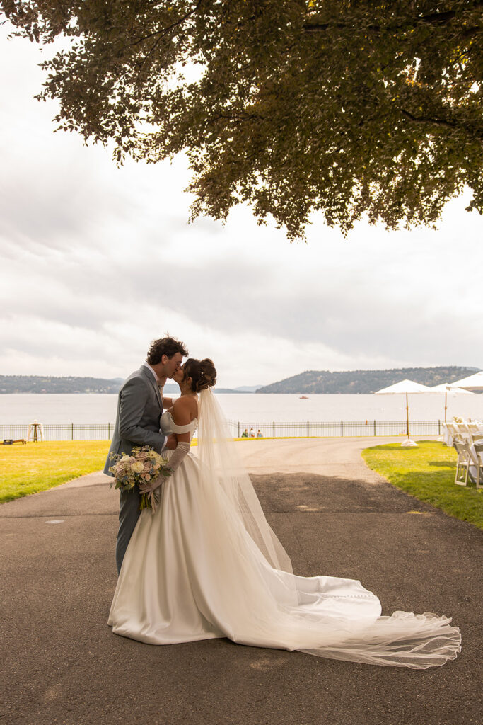 Best Places to Elope in Idaho | | Love in the Hills Photo & Video Couple kissing by the lake under a tree in one of the best places to elope in Idaho.