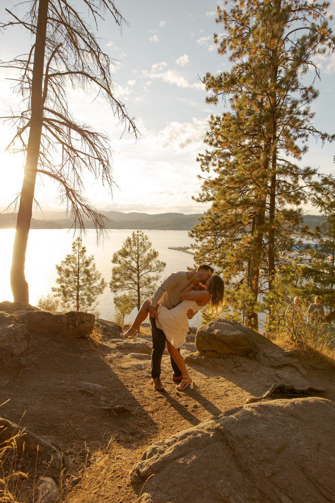 Places to Elope in Idaho | Love in the Hills Photo & Video Couple kissing at sunset on a scenic cliffside in one of the most romantic places to elope in Idaho.