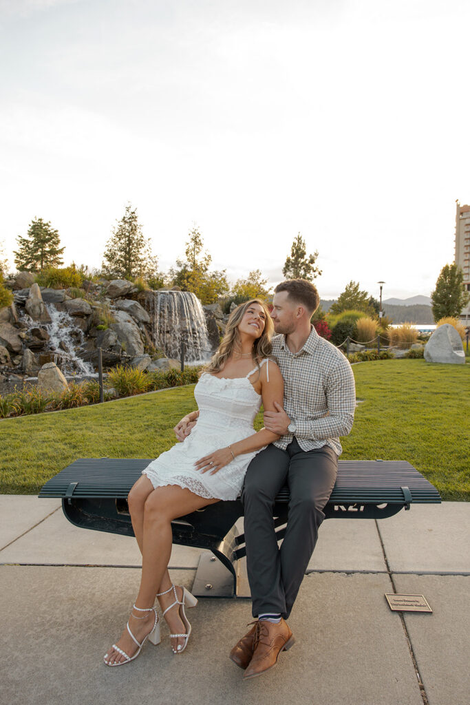 Places to Elope in Idaho | Love in the Hills Photo & Video Couple sitting together near a waterfall in a park setting among places to elope in Idaho