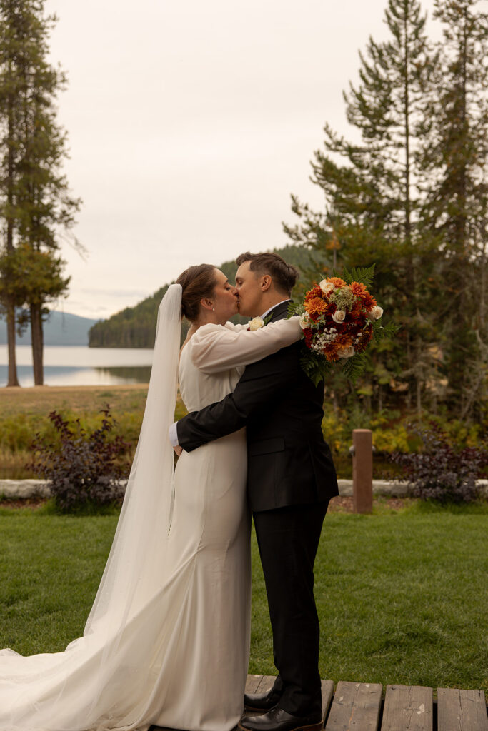 Places to Elope in Idaho | Love in the Hills Photo & Video Newlyweds kissing by the lake at one of the most scenic places to elope in Idaho.
