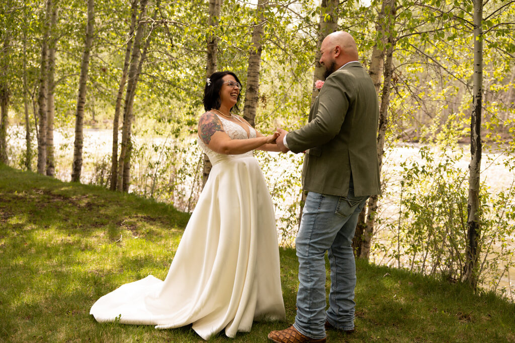 Bride and groom laugh and hold hands during their elopement in Idaho