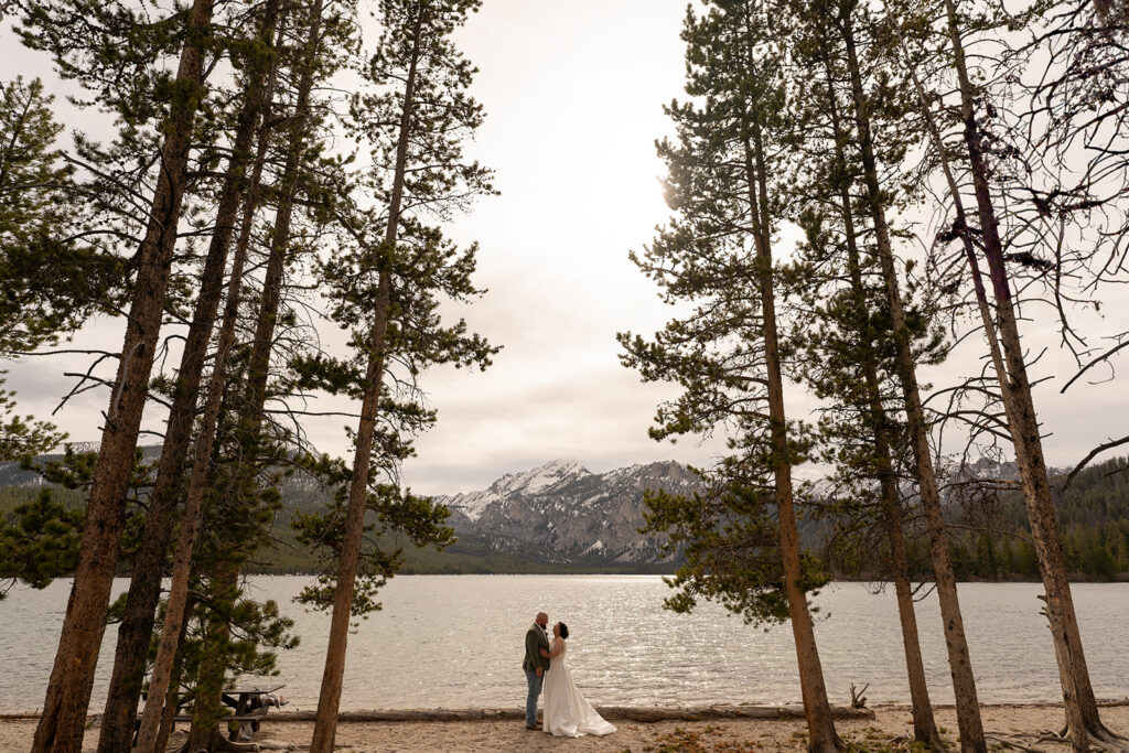 Bride and groom gaze at each other in front of the Sawtooth Mountains during their Idaho elopement