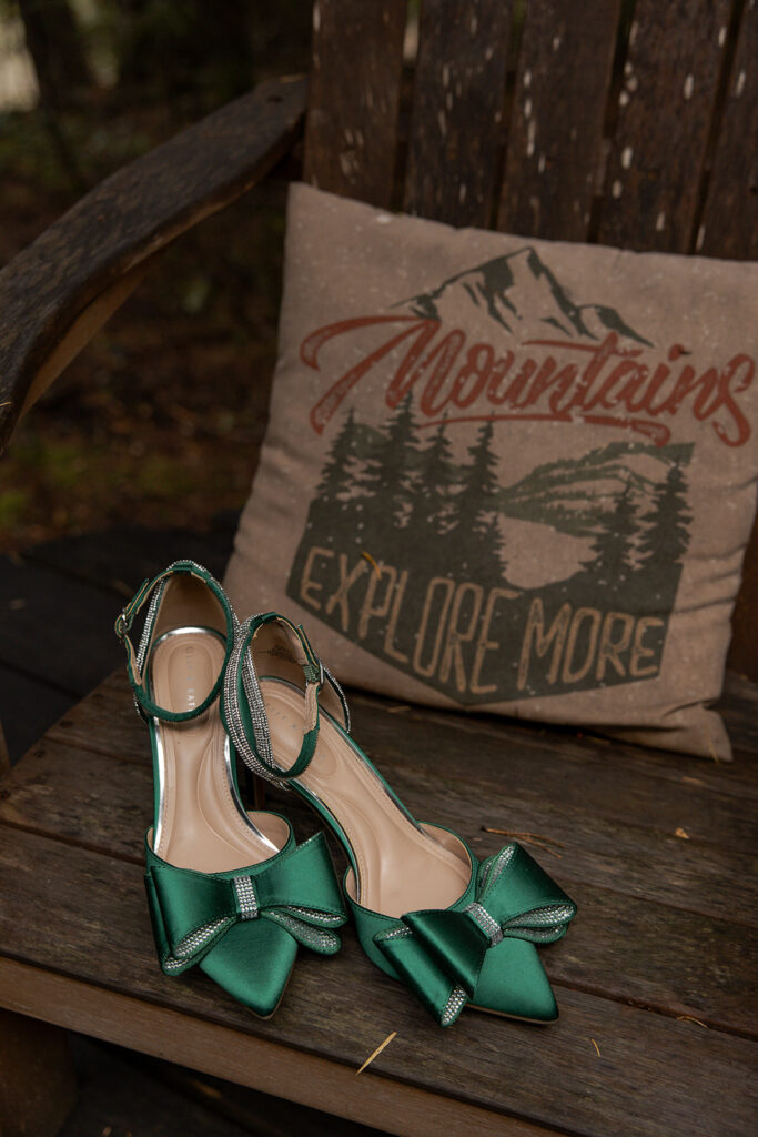 Priest Lake Idaho Wedding | Love In The Hills Photo And Video Green wedding shoes beside a mountain-themed pillow while getting ready for a Priest Lake Idaho wedding