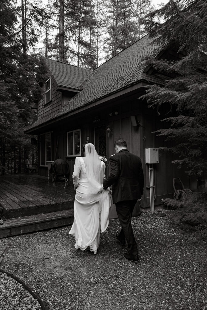 Priest Lake Idaho Wedding | Love In The Hills Photo And Video Bride and groom returning to their cabin after a Priest Lake Idaho wedding in black and white capture.