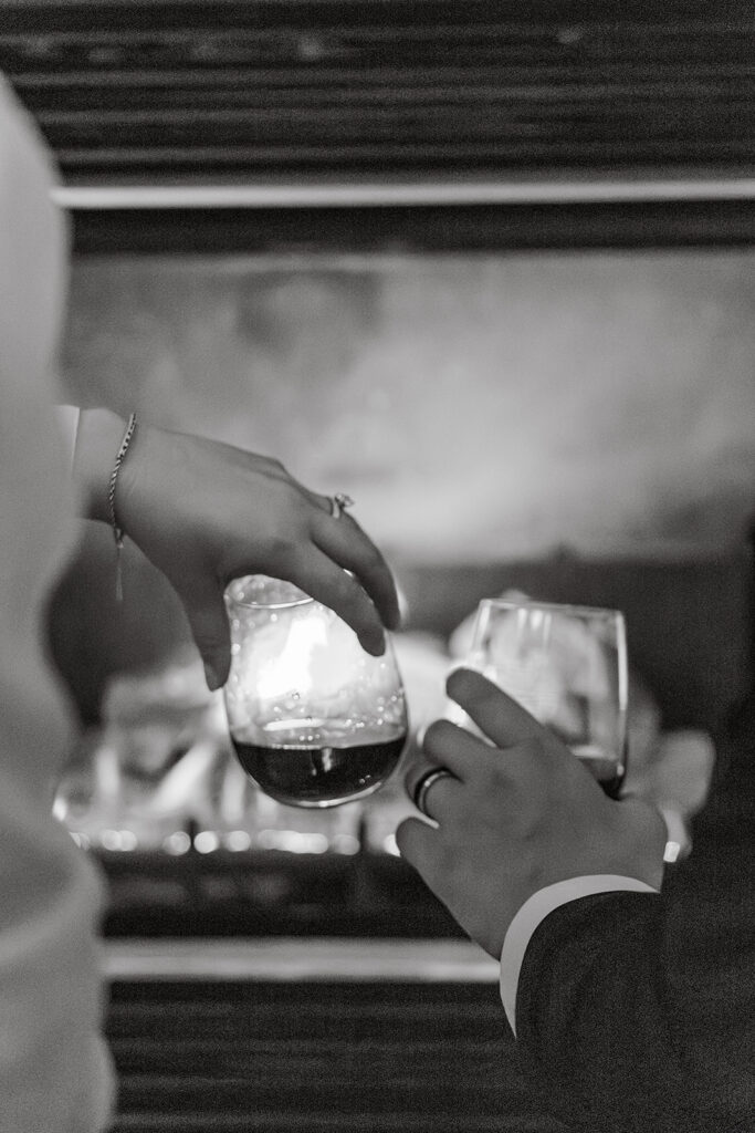 Priest Lake Idaho Wedding | Love In The Hills Photo And Video Bride and groom sharing a quiet toast by the fireplace after their Priest Lake Idaho wedding ceremony.